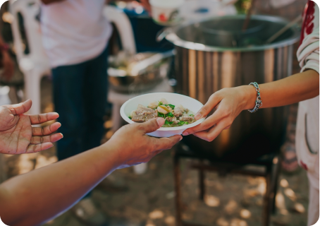Person giving a bowl of food to someone