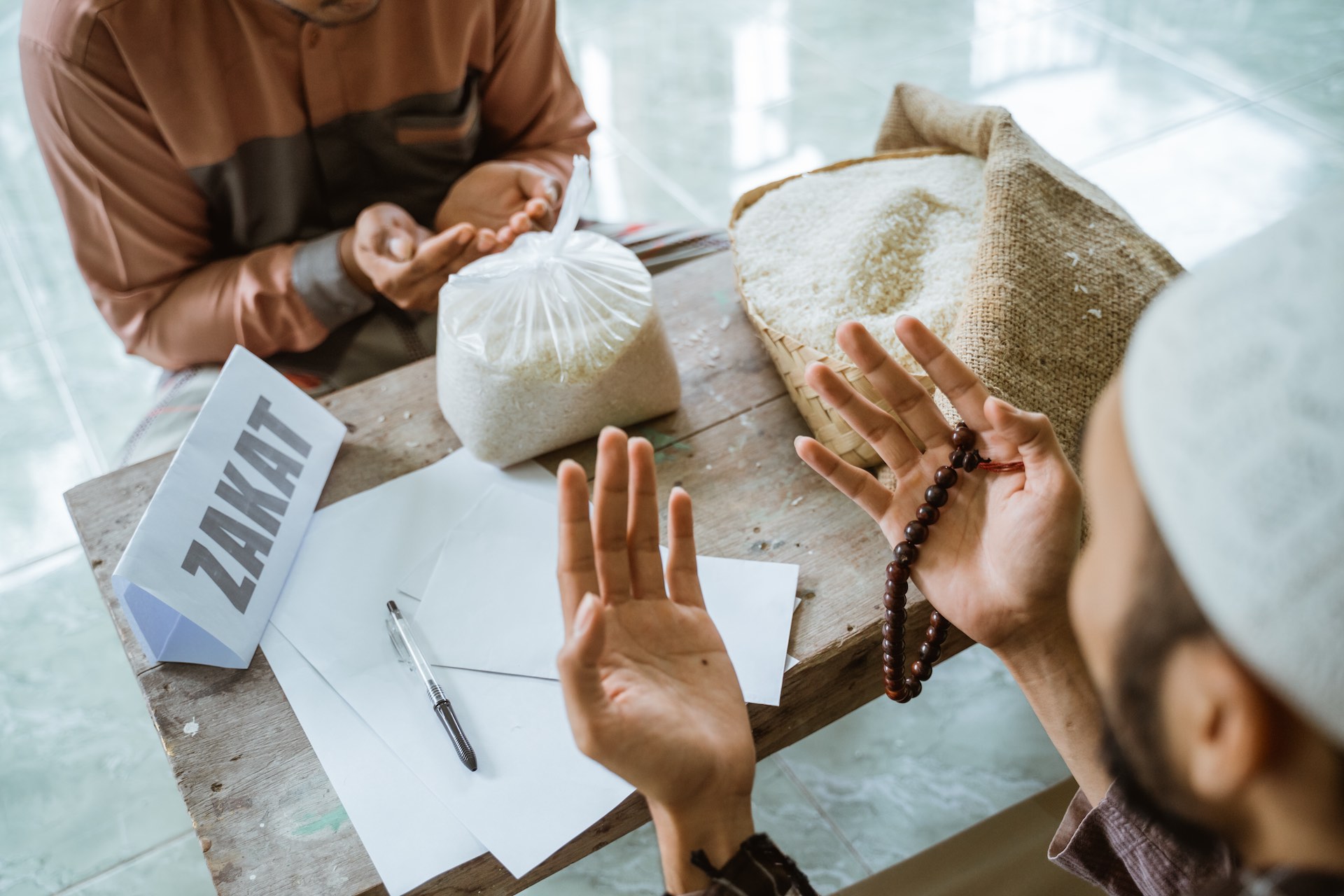 People handling rice bags and supplies